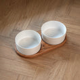 Charger l'image dans la visionneuse de la galerie, Patomia Barcelona double dog bowl with white ceramic bowls on an oiled oak wooden stand on a herringbone floor