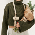 Charger l'image dans la visionneuse de la galerie, Patomia beige vegan leather dog leash with zamak hardware worn over the shoulder by a person in a green sweater