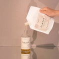 Charger l'image dans la visionneuse de la galerie, Patomia Fresh Fetch dog shampoo refill pouch pouring natural lemongrass and mint formula into a glass bottle