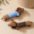 Charger l'image dans la visionneuse de la galerie, Two Patomia plush dachshund dog toys with squeakers, wearing blue gingham and red plaid outfits on a beige background.