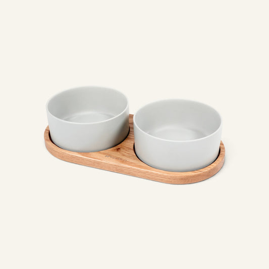 Patomia Barcelona double dog bowl set with a light oiled oak wooden base and two grey ceramic bowls.
