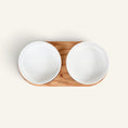 Charger l'image dans la visionneuse de la galerie, Patomia Barcelona double dog bowl with a light oiled oak wooden base and two white ceramic bowls, top view.
