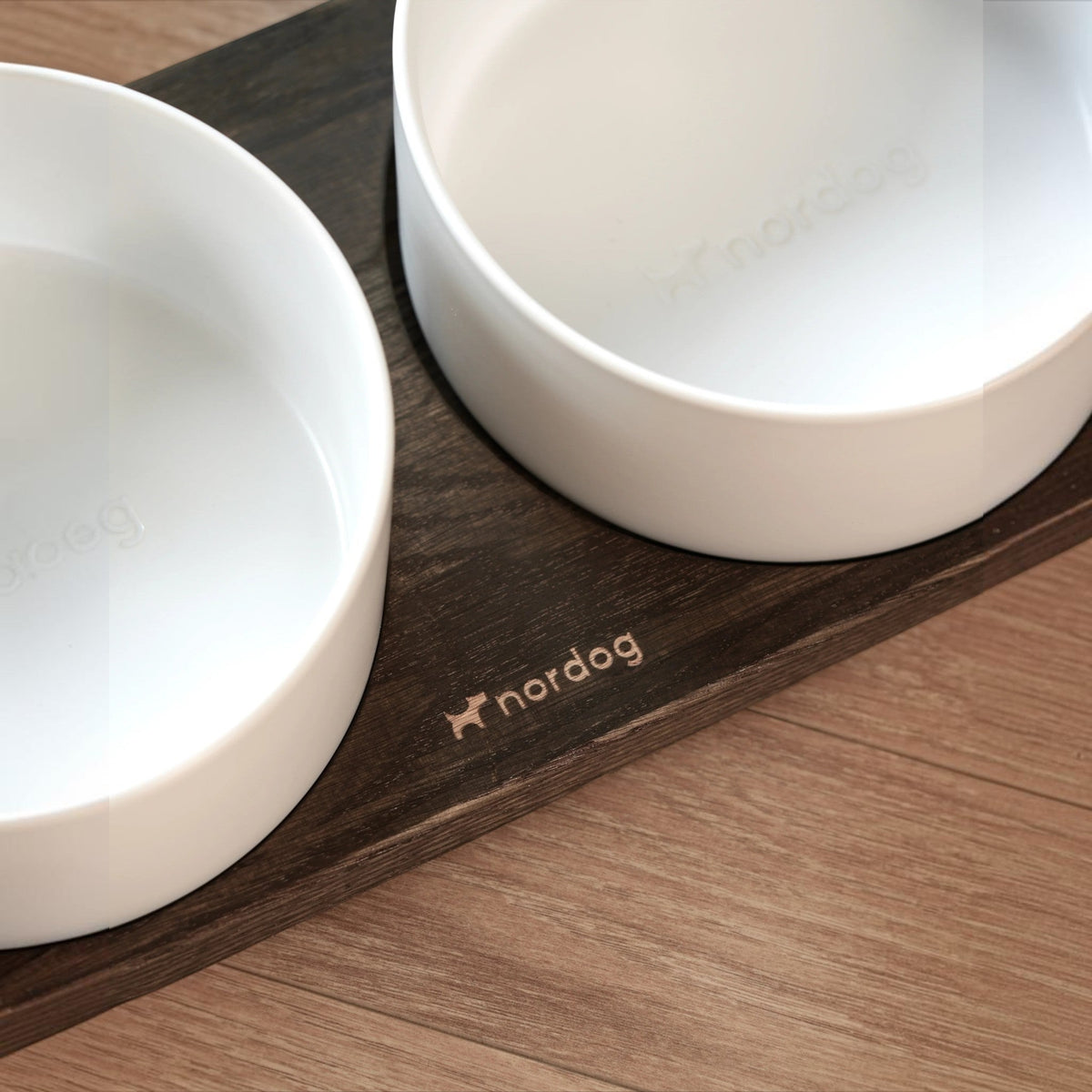 Patomia Barcelona double dog bowl with a dark smoked oak wooden base and two white ceramic bowls