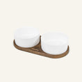 Charger l'image dans la visionneuse de la galerie, Patomia Barcelona double dog bowl with a dark smoked oak base and two white ceramic bowls on a light background.
