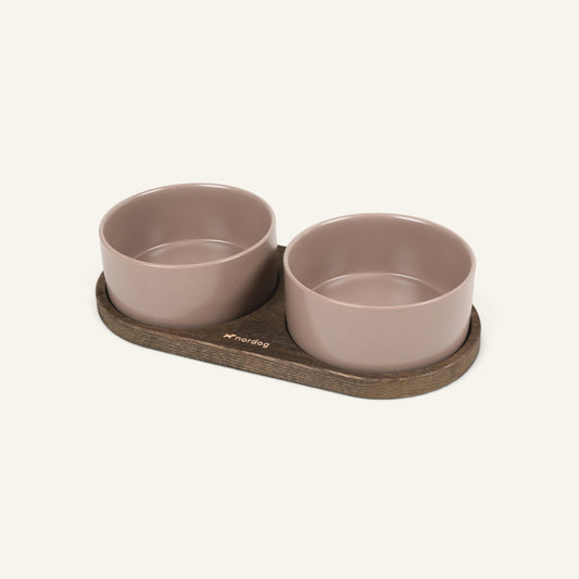 Patomia Barcelona double dog bowl with a dark smoked oak base and two mocha ceramic bowls on a light background.