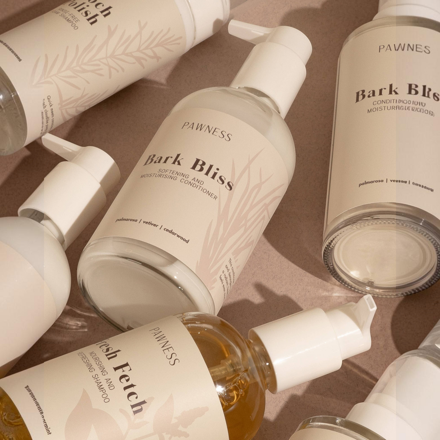 Patomia Bark Bliss dog conditioner bottles with minimalist beige labels featuring palmarosa, vetiver, and cedarwood.