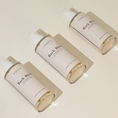 Charger l'image dans la visionneuse de la galerie, Patomia Bark Bliss natural dog conditioning spray bottles for hydrating and detangling pet fur on a beige background.
