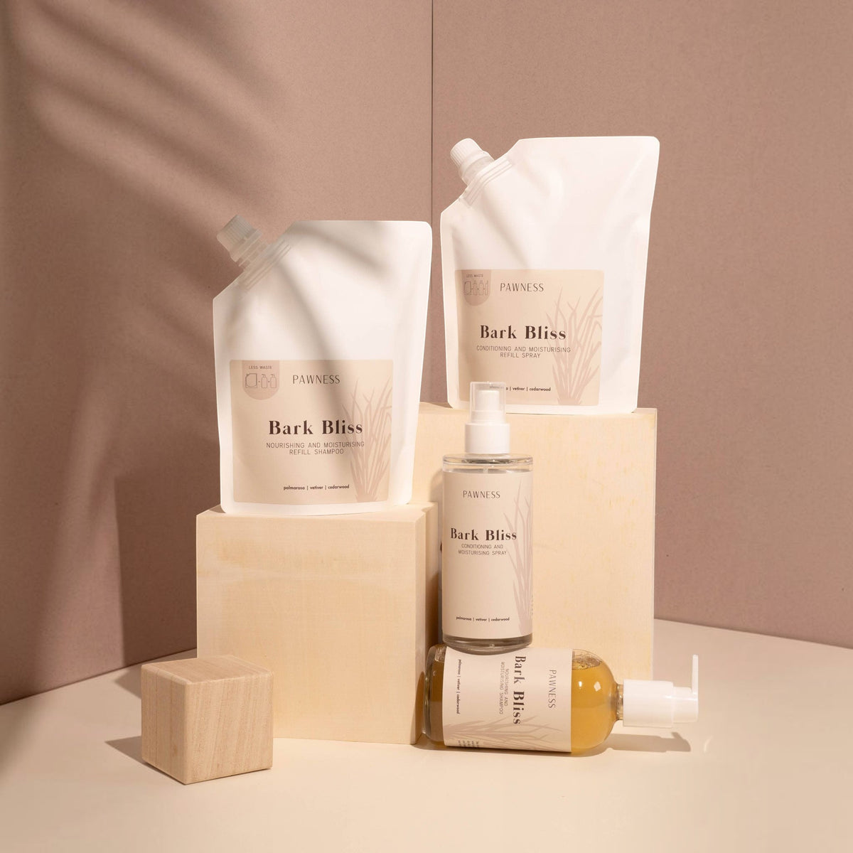 Patomia Bark Bliss dog grooming refill pouches and glass spray bottles with cedarwood, vetiver, and palmarosa scents.