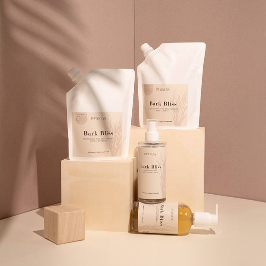 Patomia Bark Bliss dog grooming refill pouches and glass spray bottles with cedarwood, vetiver, and palmarosa scents.