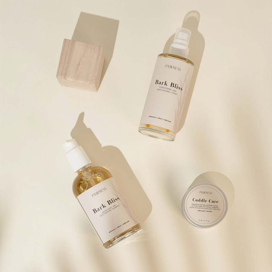 Patomia Bark Bliss dog shampoo, conditioning spray, and Cuddle Cure balm set on a neutral background
