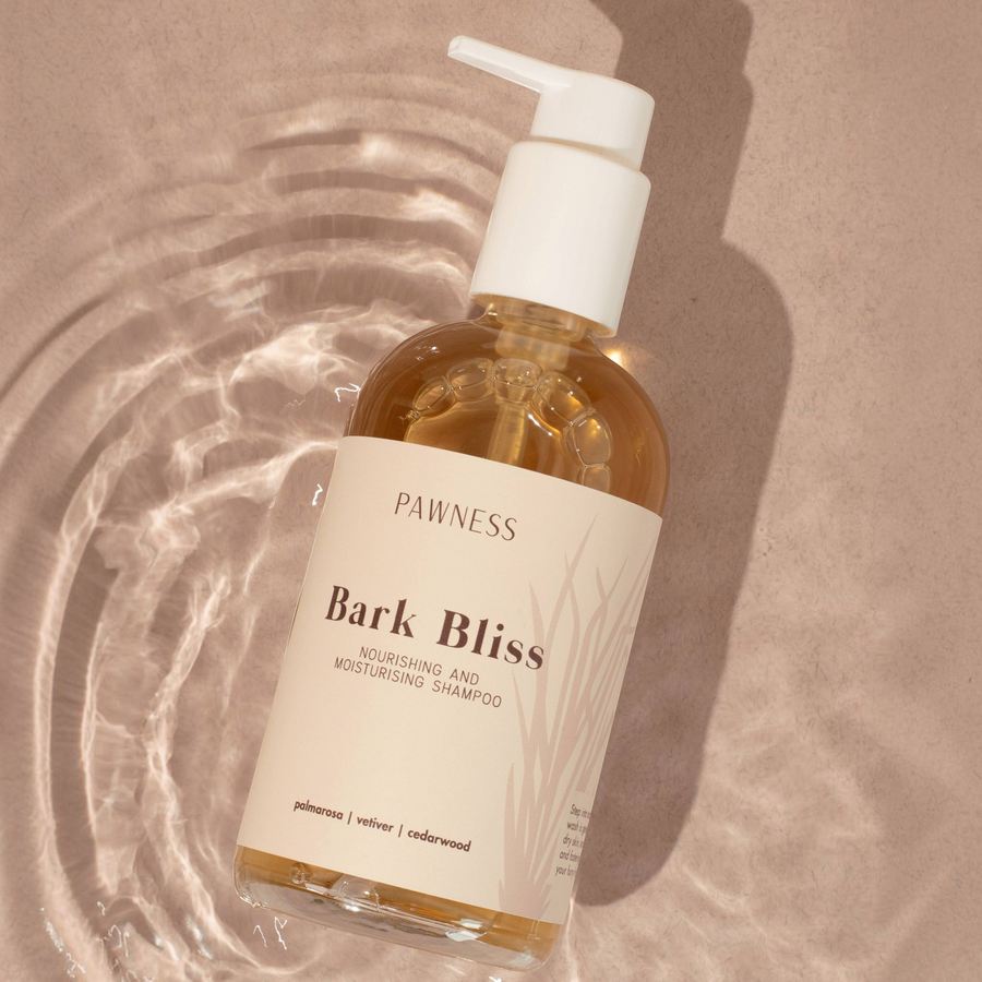 Patomia Bark Bliss natural nourishing and moisturizing dog shampoo in a 250ml pump bottle on a water-rippled surface.