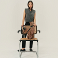 Charger l'image dans la visionneuse de la galerie, Patomia black vegan leather dog collar with zamak metal hardware worn by a dog sitting on a cane chair
