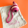 Charger l'image dans la visionneuse de la galerie, Patomia Bubble Feeder dog toy in pink and white silicone with a rope handle, resting on a branded fabric bag.
