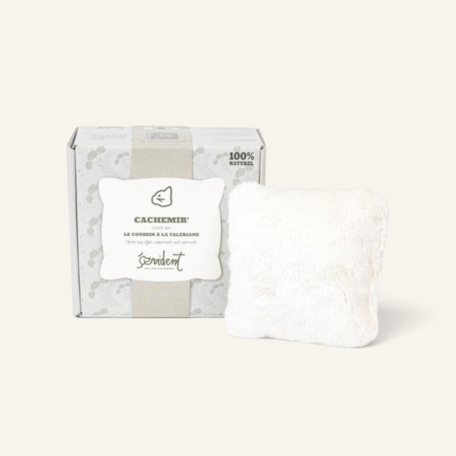 Patomia Cachemir beige valerian cat cushion toy with soft plush texture next to its branded packaging box