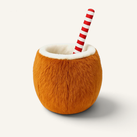 Patomia Coco Loco plush coconut dog toy with a soft brown exterior, white lining, and a red and white striped straw