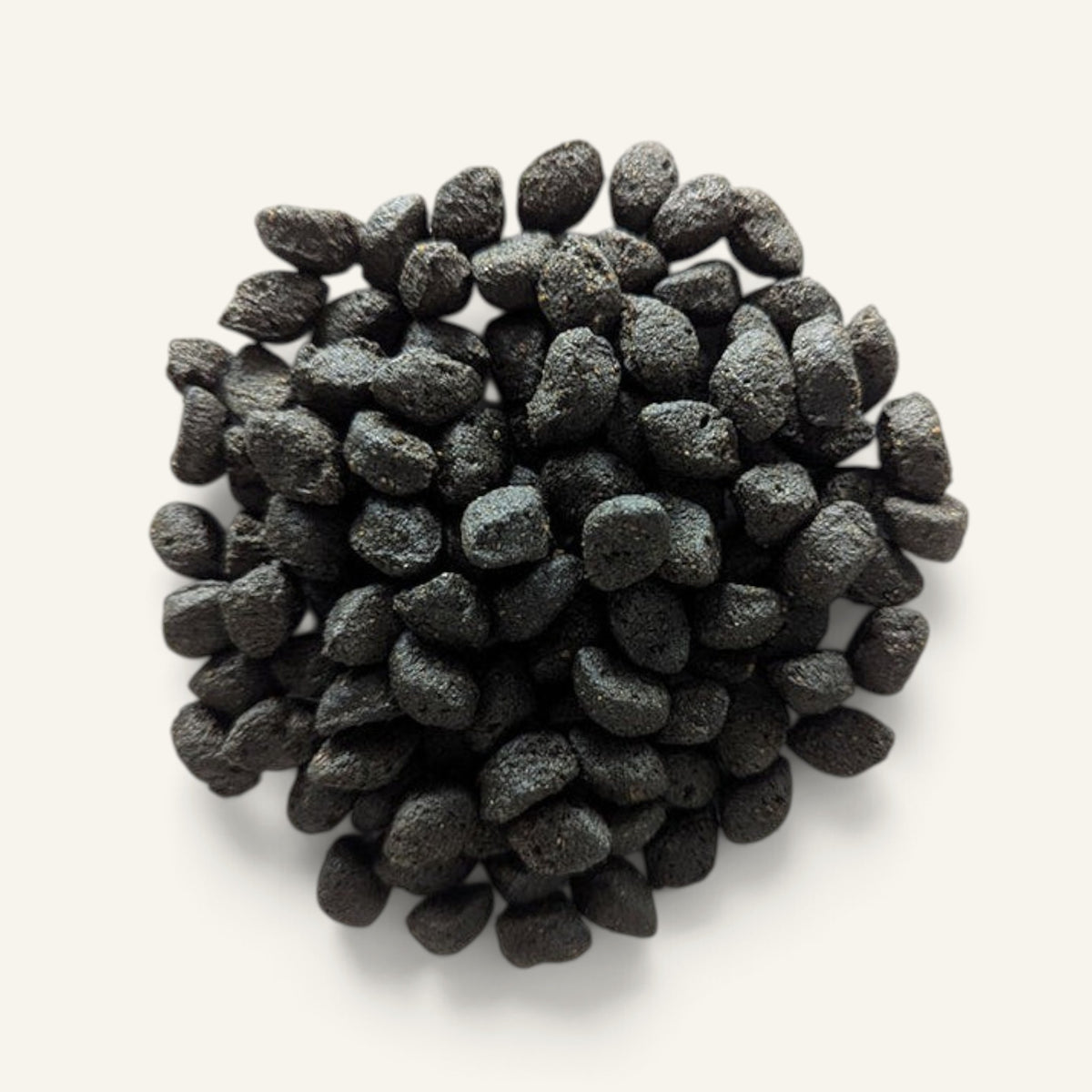 Patomia Daisy natural charcoal digestive dog treats in a small dark pile on a light background