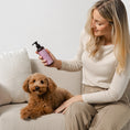 Charger l'image dans la visionneuse de la galerie, Patomia detangling conditioner for dogs and cats with long or curly hair, held by a woman next to a poodle
