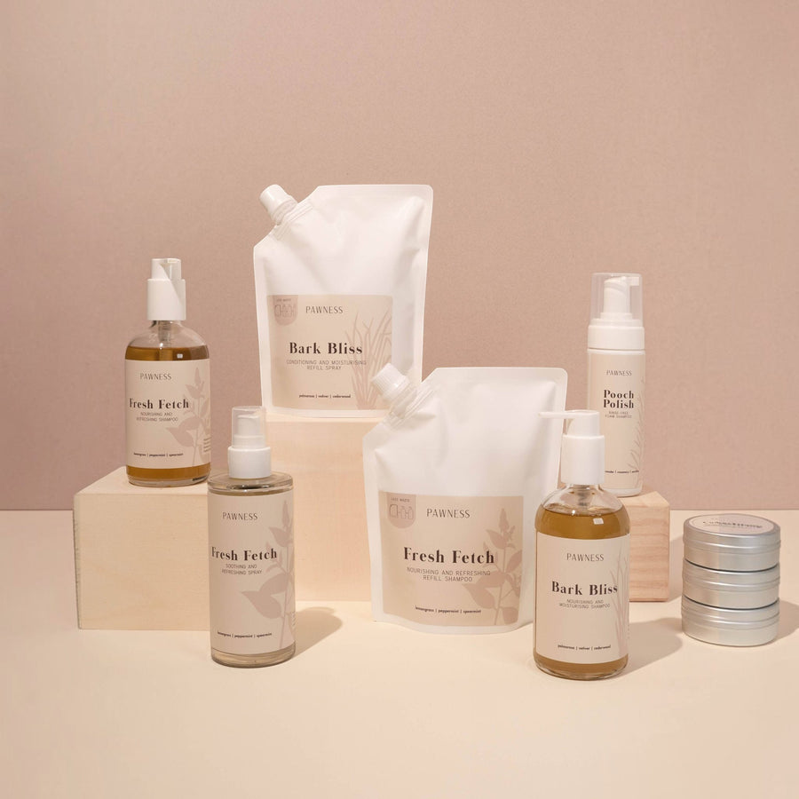 Patomia collection of natural dog grooming products including shampoo bottles, refill pouches, and grooming tins.