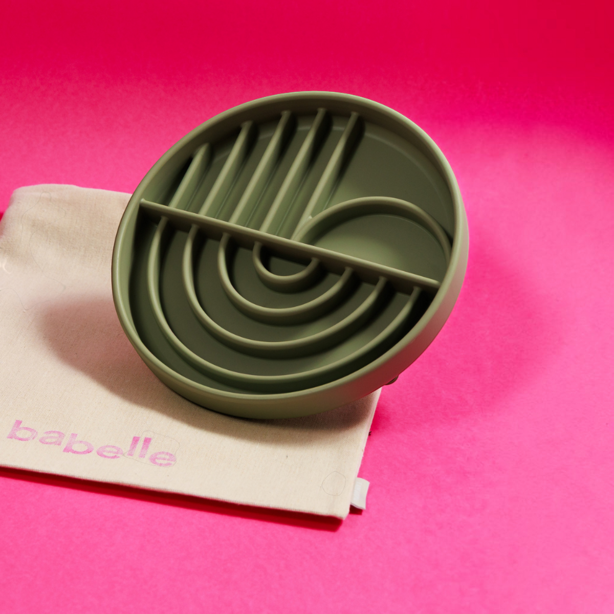 Patomia The Dreamy green silicone lickmat with a soft arch pattern for pet enrichment on a pink background.