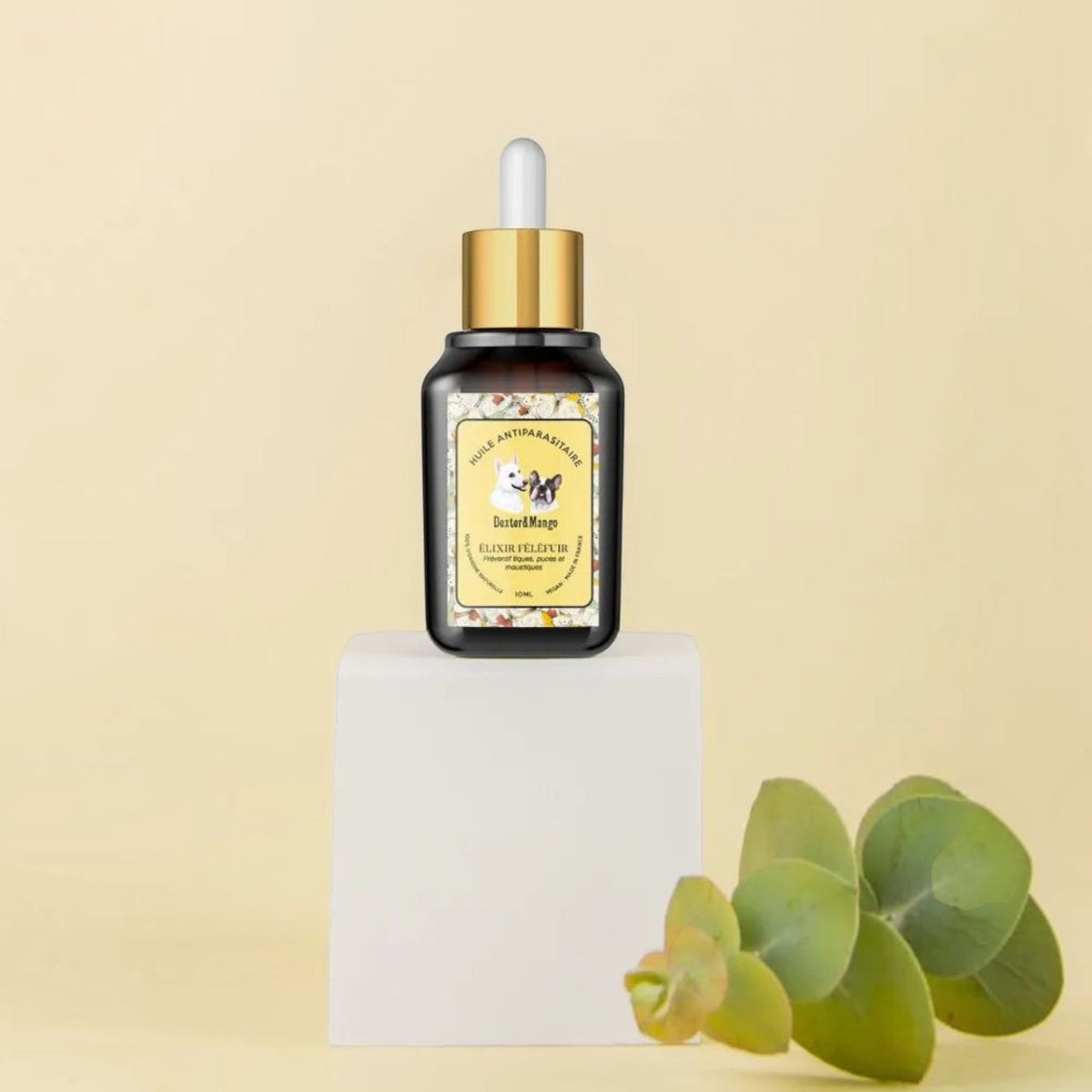 Patomia natural anti-parasite oil elixir for dogs in a 10ml amber glass dropper bottle on a white pedestal.