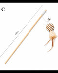 Charger l'image dans la visionneuse de la galerie, Patomia natural wood cat wand toy with a woven ball, feathers, and a bell for interactive play
