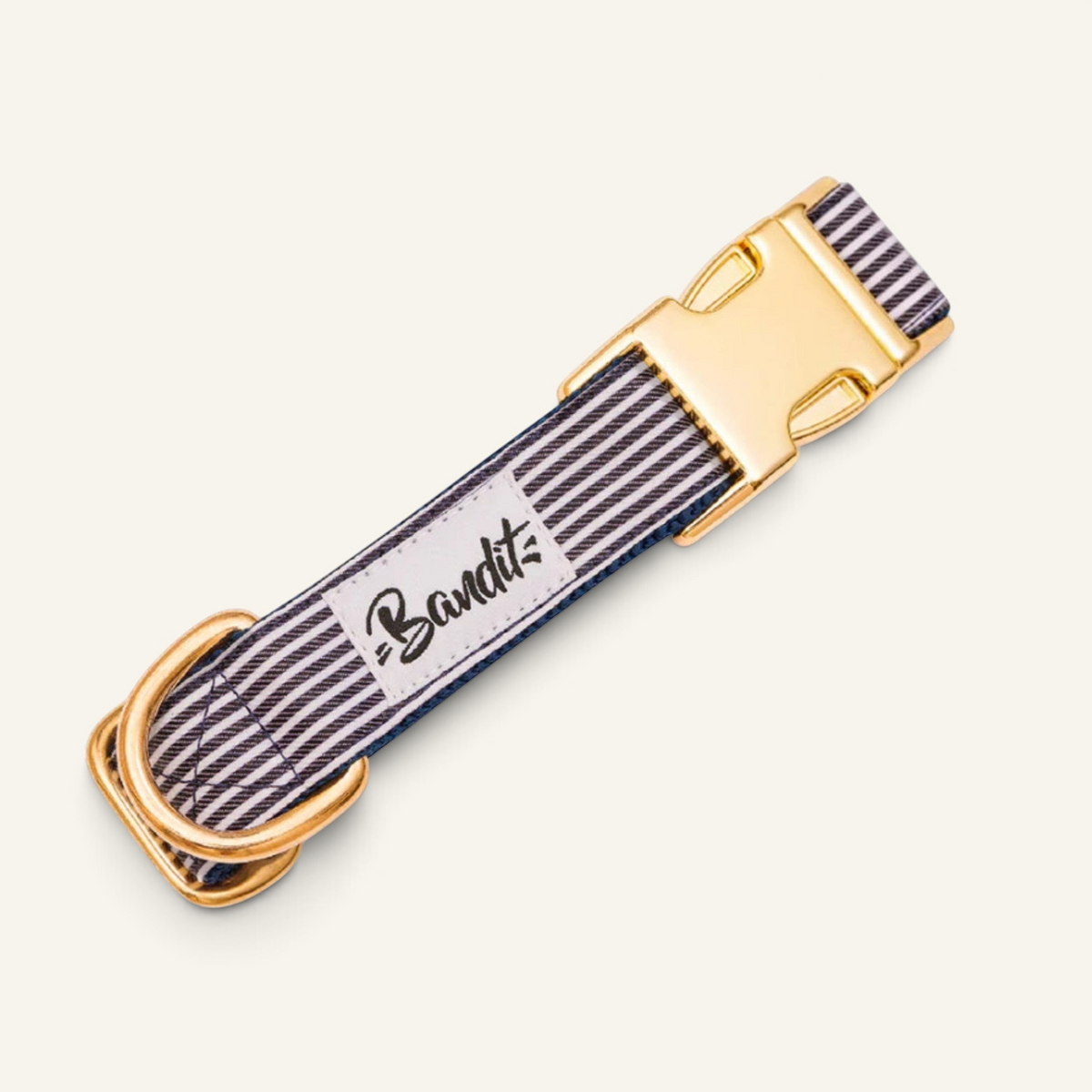 Patomia nautical striped dog collar in blue and white with gold buckle and Bandit brand label