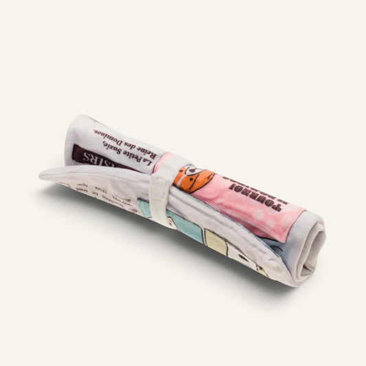 Patomia newspaper-shaped dog toy that unfolds into a soft fabric snuffle mat for hiding treats.