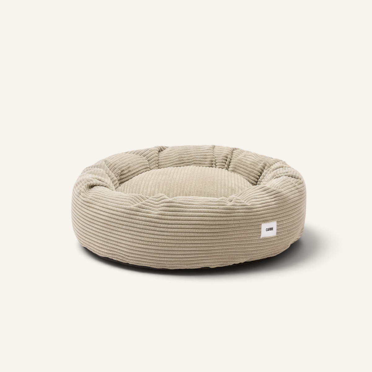 Patomia Nuba beige corduroy dog bed with a round, plush design and removable cover for easy cleaning.