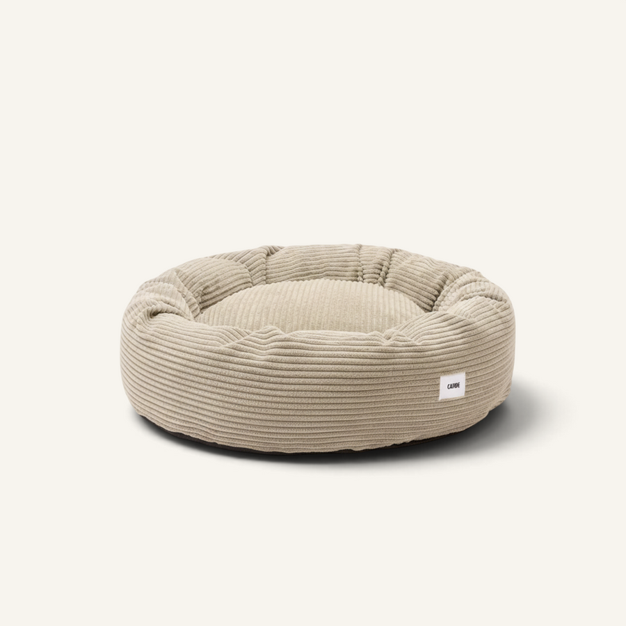 Patomia Nuba beige corduroy dog bed with a round, plush design and removable cover for easy cleaning.