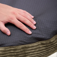 Charger l'image dans la visionneuse de la galerie, Patomia Nuba green corduroy dog bed with a non-slip dotted base being touched by a hand
