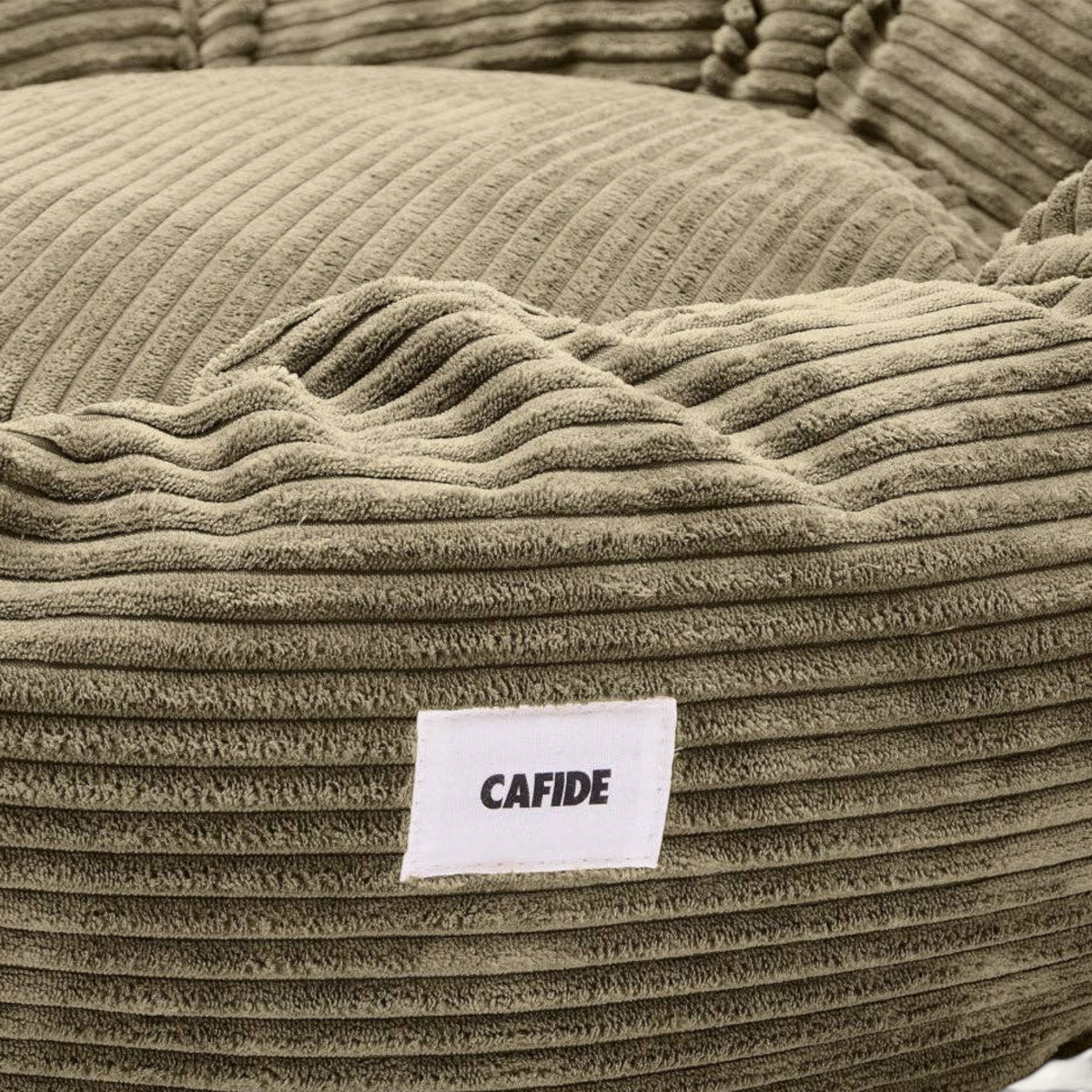 Patomia Nuba green corduroy dog bed with soft plush texture and a white brand label