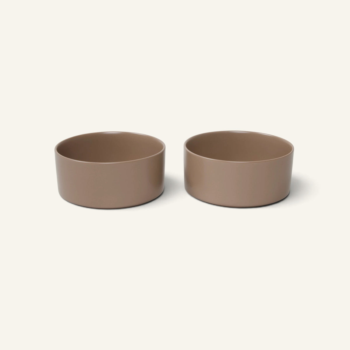 Two Patomia Oli Cacao ceramic dog bowls in a minimalist brown finish, designed for durable and stylish pet feeding.