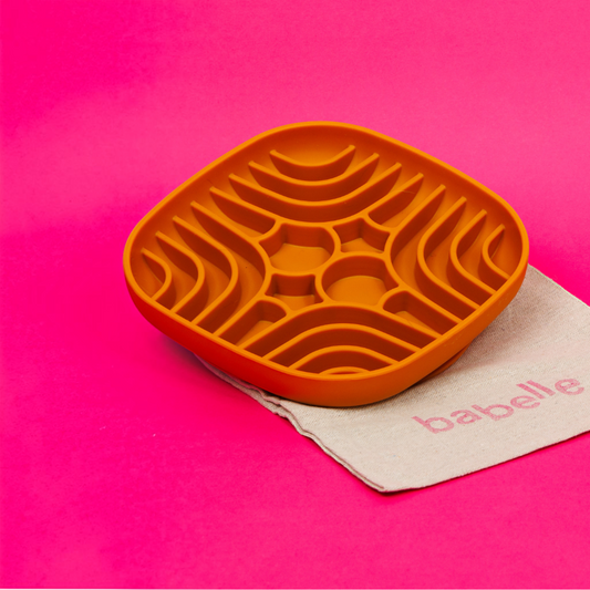 Patomia burnt orange silicone labyrinth lick mat for dogs on a bright pink background