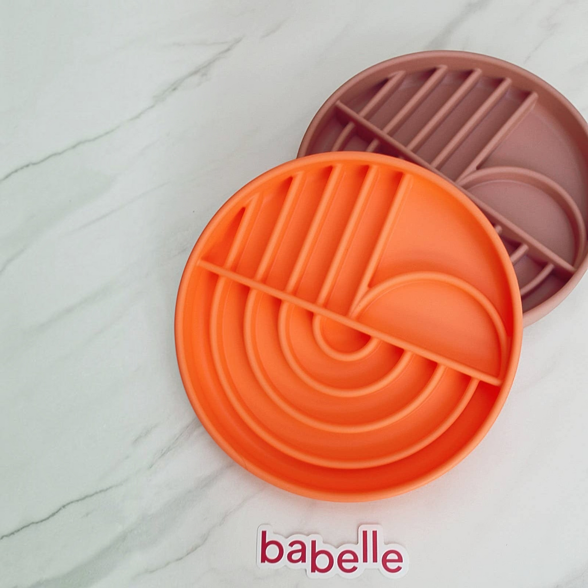 Patomia The Dreamy round orange silicone lickmat for slow feeding and pet enrichment on a marble surface
