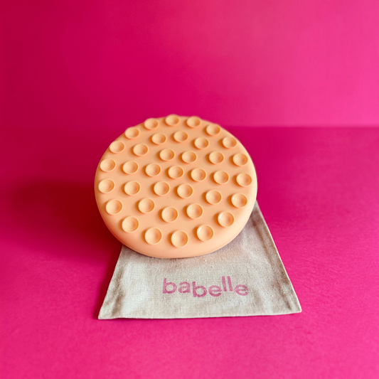 Patomia The Petal peach silicone lickmat for dogs on a linen bag against a vibrant pink background
