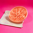 Charger l'image dans la visionneuse de la galerie, Patomia The Petal peach silicone lickmat for dogs in a flower shape on a beige cotton bag against a pink background
