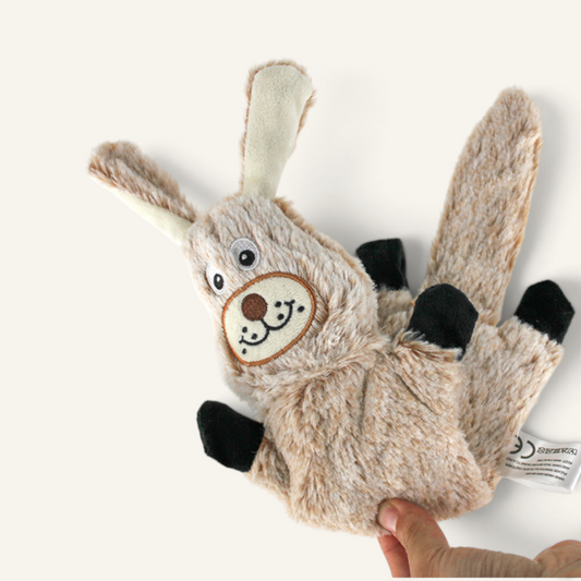 Patomia plush rabbit dog toy with soft beige fur, embroidered face, and black paws for interactive play