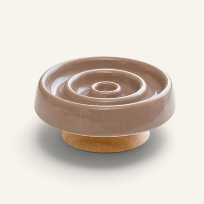 Patomia raised ceramic slow feeder bowl for cats with a spiral groove design and a stable wooden base