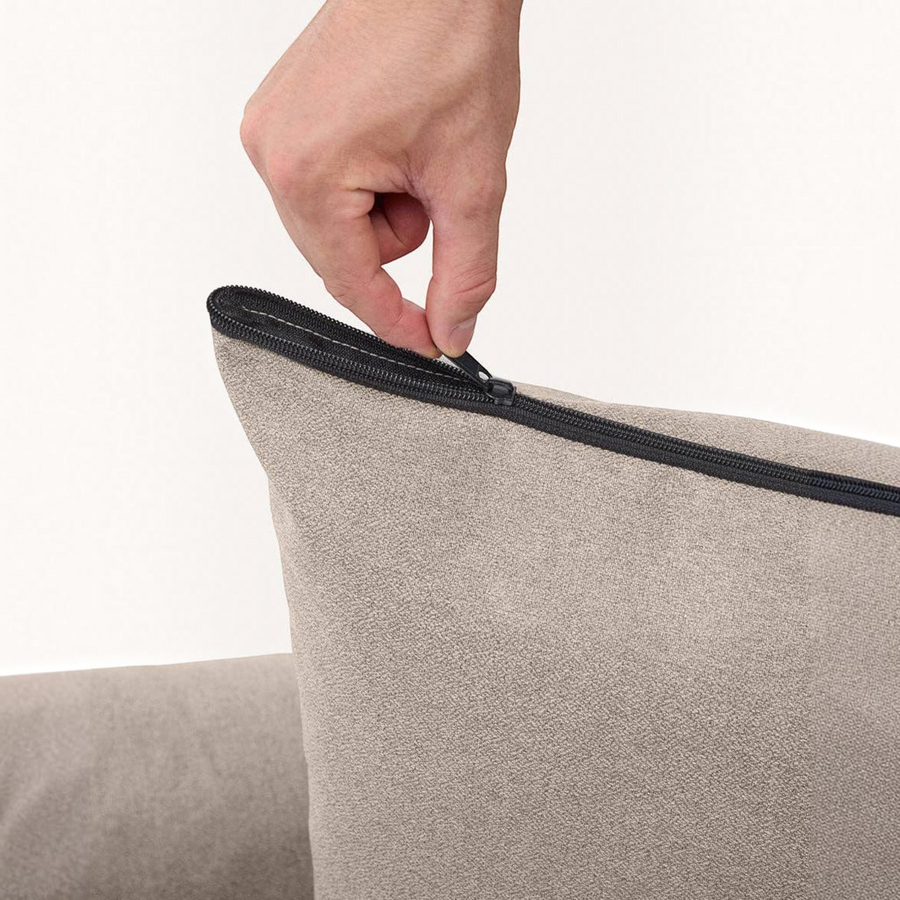 Patomia Snozy beige dog bed with a hand unzipping the removable soft polyester cover