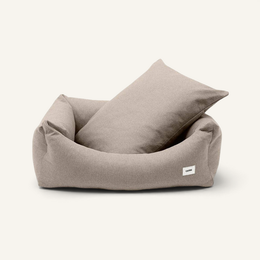 Patomia Snozy beige dog bed with soft fabric cover and adjustable recycled foam filling on a light background