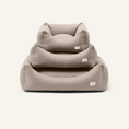 Charger l'image dans la visionneuse de la galerie, Patomia Snozy beige dog bed basket with soft removable cover and recycled foam filling, shown in three sizes stacked.
