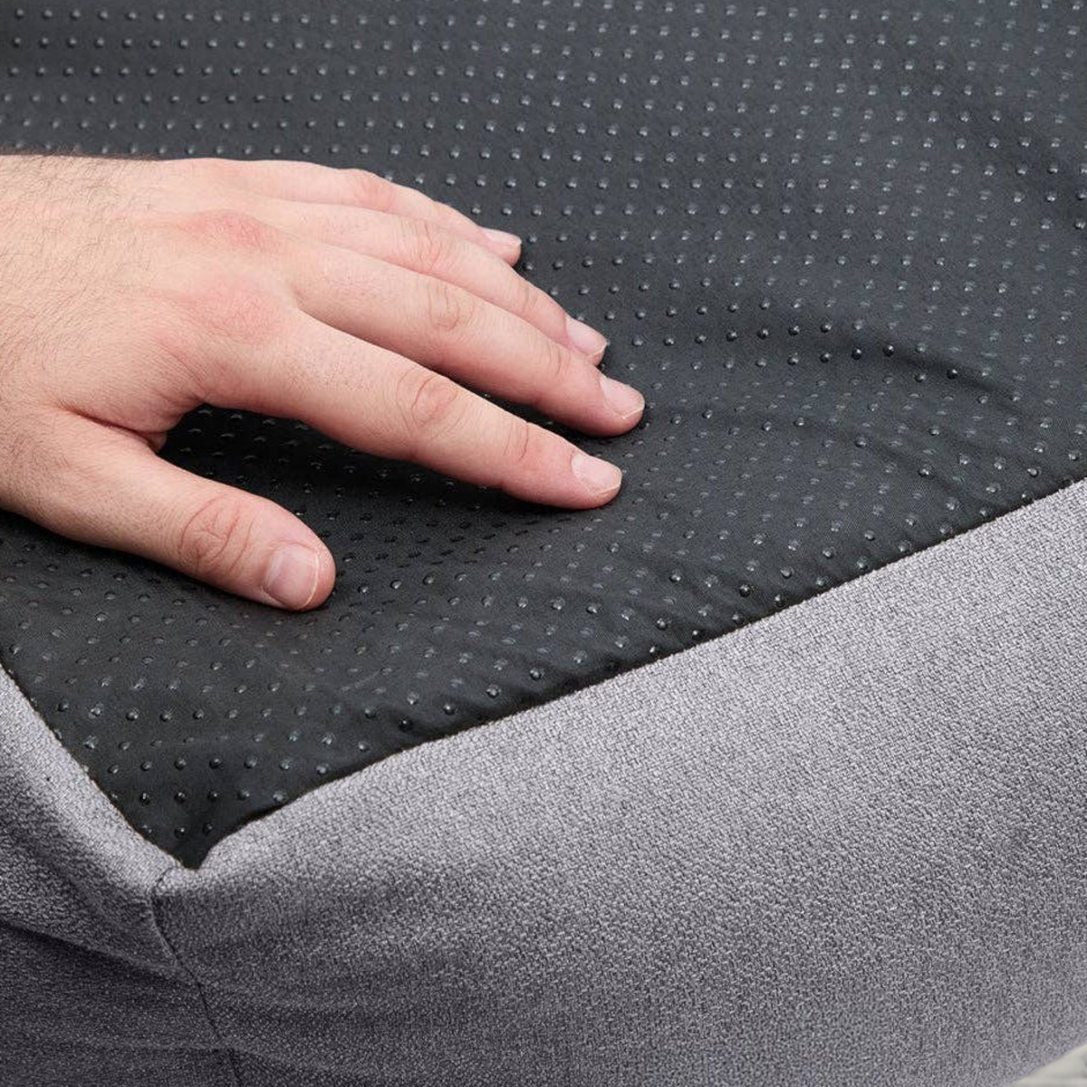 Patomia Snozy grey dog bed featuring a durable black non-slip base with textured grip dots for stability.