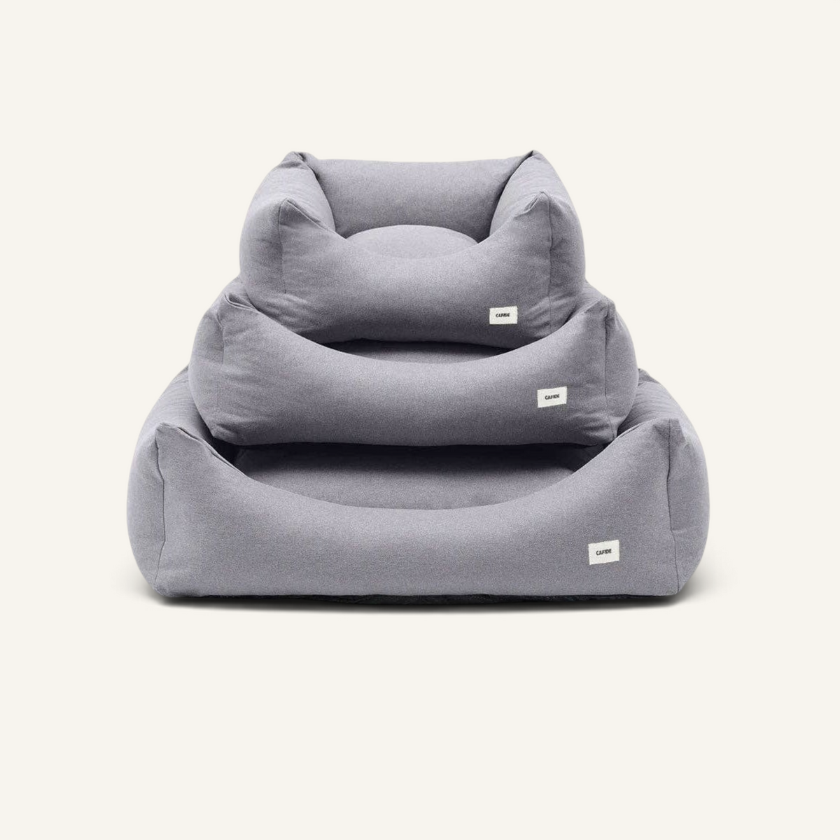 Patomia Snozy grey dog bed basket in three sizes stacked, made of soft polyester fabric with removable cover.